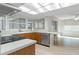 Well-lit kitchen with breakfast bar, tiled floors, and adjacent sunroom at 2692 Royal Ridge Dr, Spring Hill, FL 34606
