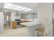 Bright kitchen featuring stainless steel appliances, a breakfast bar, and a view to the living area at 2692 Royal Ridge Dr, Spring Hill, FL 34606