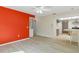Bright living room featuring a colorful accent wall, wood-look floors, and an open layout to the kitchen at 2692 Royal Ridge Dr, Spring Hill, FL 34606