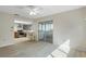 Bright and open living area flowing into the kitchen and featuring sliding door access to the sunroom at 2692 Royal Ridge Dr, Spring Hill, FL 34606