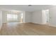 Open living area with modern vinyl floors, neutral walls, and sliding door access at 2692 Royal Ridge Dr, Spring Hill, FL 34606