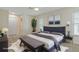 Staged bedroom with a large bed, stylish decor, wood-look floors, and access to ensuite bathroom at 2692 Royal Ridge Dr, Spring Hill, FL 34606