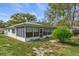 This home has a covered and screened lanai on the back side of the house with mature landscaping at 2692 Royal Ridge Dr, Spring Hill, FL 34606