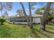 The screened in lanai of this home backs up to a mature landscaped yard with green grass at 2692 Royal Ridge Dr, Spring Hill, FL 34606