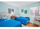 Bright bedroom featuring twin beds, playful art, and a window providing natural light at 2700 56Th S St, Gulfport, FL 33707