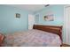 Bright bedroom with blue walls, a wooden bed frame, and beach-themed artwork at 2700 56Th S St, Gulfport, FL 33707