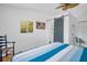 Well-lit bedroom with blue accents and a barn door leading to the en-suite bath at 2700 56Th S St, Gulfport, FL 33707
