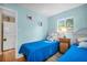 A cheery bedroom with two twin beds, a window, and a laundry unit for added convenience at 2700 56Th S St, Gulfport, FL 33707