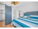 Serene bedroom with wood look floors, sliding barn door, and blue accents at 2700 56Th S St, Gulfport, FL 33707