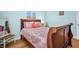 Cozy bedroom featuring an inviting wood bed frame and beach-themed decor at 2700 56Th S St, Gulfport, FL 33707