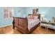 Cozy bedroom featuring beachy decor and a wooden frame bed with warm lighting at 2700 56Th S St, Gulfport, FL 33707