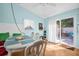 Bright dining area featuring a stylish table, comfortable seating, and sliding glass door access to the outdoor space at 2700 56Th S St, Gulfport, FL 33707