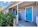 Inviting front porch with a bright blue door and comfortable rocking chairs, perfect for relaxing outdoors at 2700 56Th S St, Gulfport, FL 33707