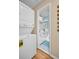 Hallway with a stacked washer/dryer and a view into the bright, updated bathroom at 2700 56Th S St, Gulfport, FL 33707