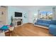 Cozy living room featuring hardwood floors, a comfortable sofa, and a modern entertainment center for relaxation at 2700 56Th S St, Gulfport, FL 33707