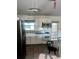 Functional kitchen with stainless steel refrigerator, white cabinets, and tile floor at 3005 W 18Th W Ave, Bradenton, FL 34205