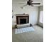 Living room with fireplace, ceiling fan, and neutral carpet at 3005 W 18Th W Ave, Bradenton, FL 34205