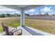 Spacious backyard with lush green grass and a covered patio, creating an ideal outdoor space for relaxation and entertainment at 3024 Living Coral St, Wimauma, FL 33598