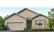 Charming single-story home featuring a two-car garage and stone accents at 3024 Living Coral St, Wimauma, FL 33598