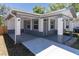 View of the home's exterior, highlighting the covered parking and entrance with accent brickwork at 3205 E North Bay St, Tampa, FL 33610
