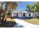 Beautifully renovated single-story home with a fresh lawn and a long driveway leading to the house at 3205 E North Bay St, Tampa, FL 33610