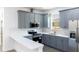 Modern kitchen featuring gray cabinets, stainless steel appliances, and a white countertop at 3205 E North Bay St, Tampa, FL 33610