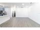 Open-concept living area with neutral walls and vinyl flooring, providing a blank canvas for personalization at 3205 E North Bay St, Tampa, FL 33610