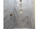 Walk-in shower featuring elegant tile work, a modern shower head and a built-in niche at 3205 E North Bay St, Tampa, FL 33610