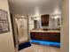 Bathroom featuring double vanity, granite counters, updated lighting, and a glass enclosed shower at 321 Parkside Ln, Safety Harbor, FL 34695