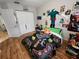 The bedroom features wood floors, a video game-themed comforter, and white walls with decor accents at 321 Parkside Ln, Safety Harbor, FL 34695