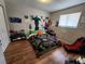 The bedroom is decorated with a video game theme and features a mounted television and light wood floors at 321 Parkside Ln, Safety Harbor, FL 34695