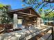 Cabana exterior with covered seating, fence, plants, and table and chairs at 321 Parkside Ln, Safety Harbor, FL 34695