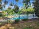 Fenced community pool area with plenty of lounge chairs, offering a safe and relaxing outdoor space at 321 Parkside Ln, Safety Harbor, FL 34695