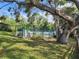 Inviting community pool with lounge chairs and a fenced perimeter, perfect for relaxing and enjoying the outdoors at 321 Parkside Ln, Safety Harbor, FL 34695