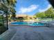 Community pool and lounge area with plenty of seating and a secure fence, perfect for residents to relax and socialize at 321 Parkside Ln, Safety Harbor, FL 34695