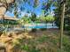 Fenced community pool area with lounge chairs offers a safe and tranquil atmosphere for residents at 321 Parkside Ln, Safety Harbor, FL 34695