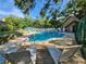 Community pool with lounge chairs surrounded by lush greenery, offering a private outdoor escape at 321 Parkside Ln, Safety Harbor, FL 34695