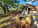 Cabana grilling area with stone grill, table, and plants, with a view of the pond at 321 Parkside Ln, Safety Harbor, FL 34695