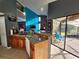 Open kitchen featuring granite counters, wood cabinets, and access to a screened lanai at 321 Parkside Ln, Safety Harbor, FL 34695