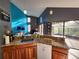 Kitchen area showcasing granite countertops, wood cabinetry, and views of the living area and lanai at 321 Parkside Ln, Safety Harbor, FL 34695