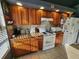 Charming kitchen with wood cabinets, tile backsplash, and modern appliances at 321 Parkside Ln, Safety Harbor, FL 34695