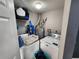 Small laundry room with washer, dryer, overhead shelf and hot water heater at 321 Parkside Ln, Safety Harbor, FL 34695