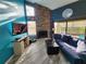 Living room with stone fireplace, high ceilings, and sliding glass doors to the outdoor patio at 321 Parkside Ln, Safety Harbor, FL 34695