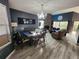 Open-concept living area with wood-look floors, a fireplace, dining area, and abundant natural light at 321 Parkside Ln, Safety Harbor, FL 34695