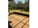 Screened in patio with wood floor and a view of the back yard at 321 Parkside Ln, Safety Harbor, FL 34695