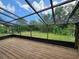 This screened-in patio boasts a beautiful view of the green, fenced-in backyard at 321 Parkside Ln, Safety Harbor, FL 34695