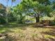 Scenic view of the pond with a glimpse of the cabana, trees, and greenery at 321 Parkside Ln, Safety Harbor, FL 34695