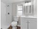 Bright bathroom features a walk-in shower, modern vanity, and new toilet at 3413 N 12Th St, Tampa, FL 33605