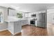 Modern kitchen with stainless steel appliances, white cabinets, and breakfast bar at 3413 N 12Th St, Tampa, FL 33605