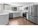 Bright kitchen featuring stainless steel appliances, white cabinetry, and modern finishes at 3413 N 12Th St, Tampa, FL 33605